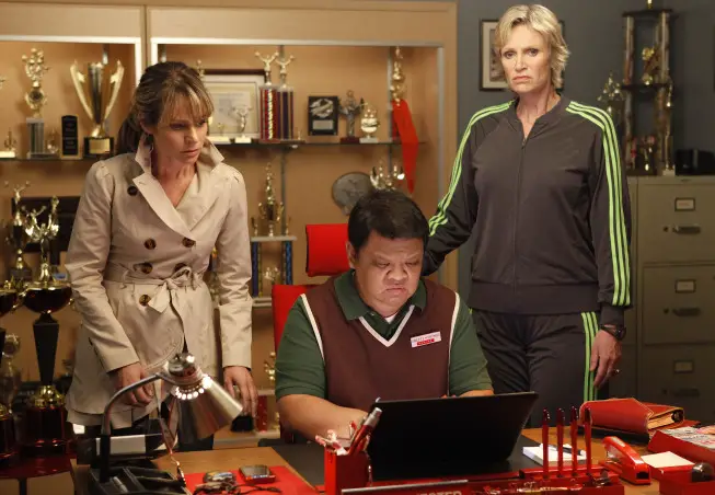 GLEE: Sue (Jane Lynch,  R) recruits Terri (Jessalyn Gilsig,  L) and Howard (guest star Kent Avenido,  C) to stop the glee club from going to Nationals in the "Funeral" episode of GLEE airing Tuesday,  May 17 (8:00-9:01 PM ET/PT) on FOX. ©2011 Fox Broadcasting Co. CR: Beth Dubber/FOX